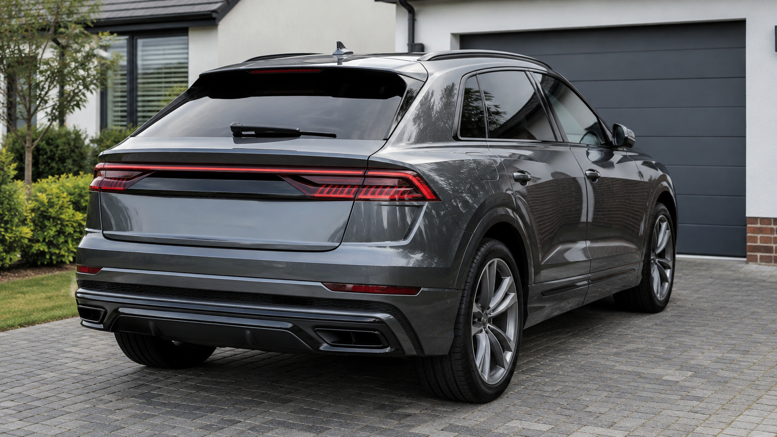 Illustrative grey Audi Q8 parked on a UK driveway in natural daylight.