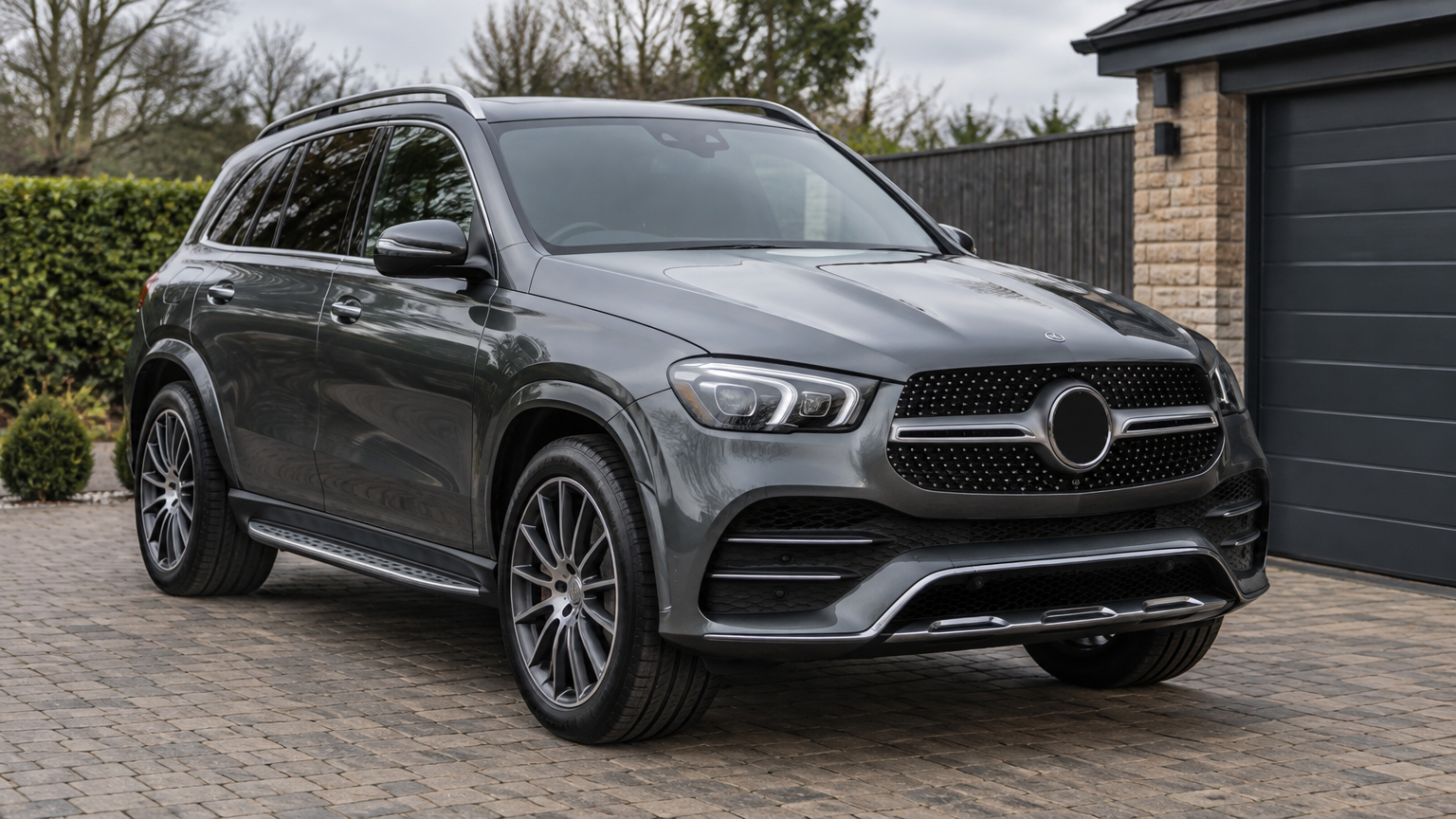 Illustrative grey Mercedes-Benz GLE parked on a UK residential driveway in natural daylight.